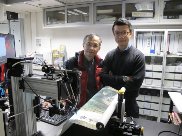 Professor Cheung Nai-ho (left) and Dr Bruno Cai (right) demonstrate using the patented laser technique to analyse the chemical information of cinnabars on a Chinese painting.