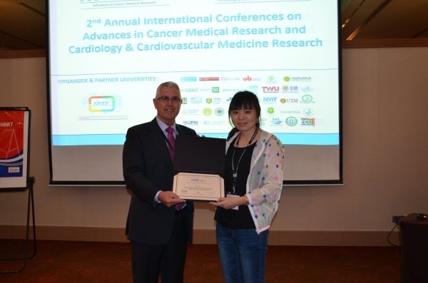 Miss Su Tao (right) receives the “Best Student Research Paper Award” at the 2nd Annual International Conference on Advances in Cancer Medical Research