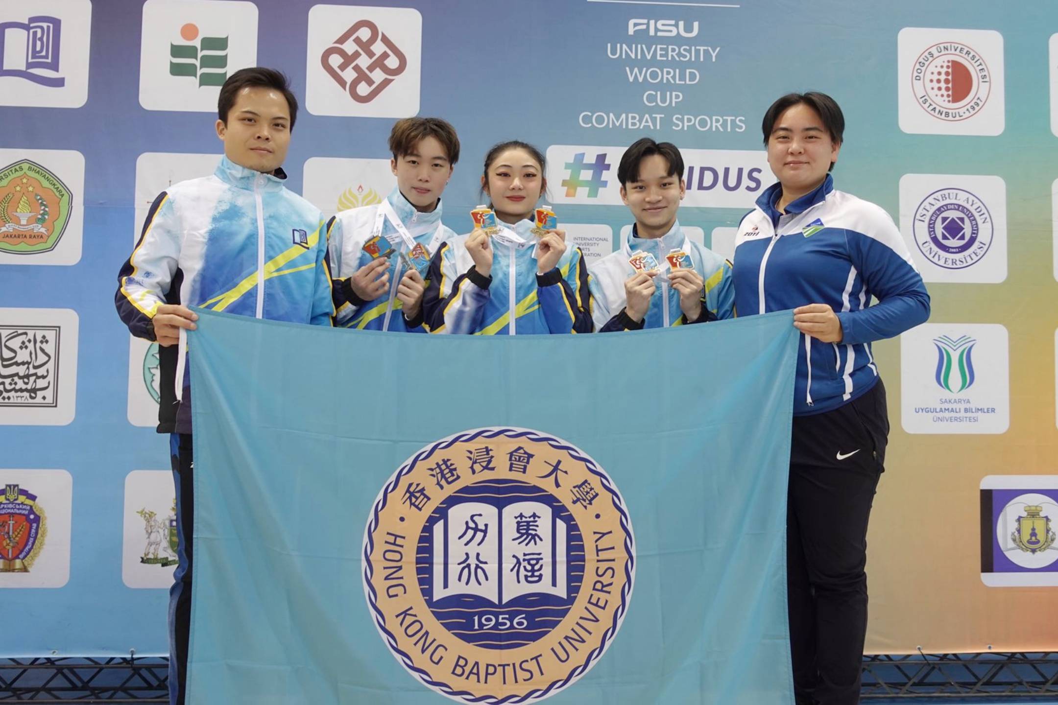 Three HKBU students (from second left) – Ho Yin-cheng, Lau Po-yan and Sat Pak-long – claimed four gold and two silver medals at the 2022 FISU University World Cup Combat Sports competition.