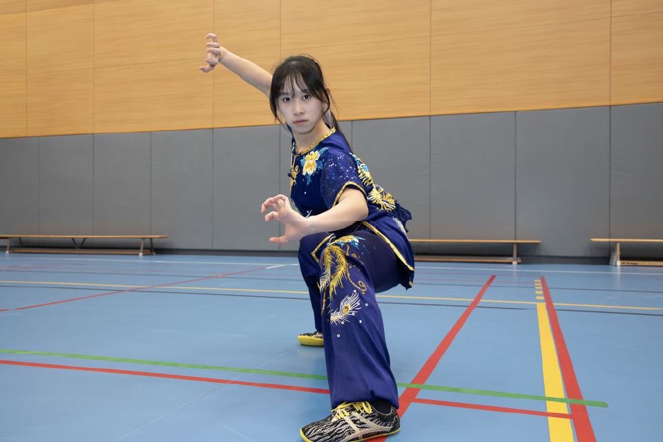 Tsang Cho-kiu, a Bachelor of Science student, skillfully balances her academic and Wushu training, aiming to integrate AI for the advancement of the sport.