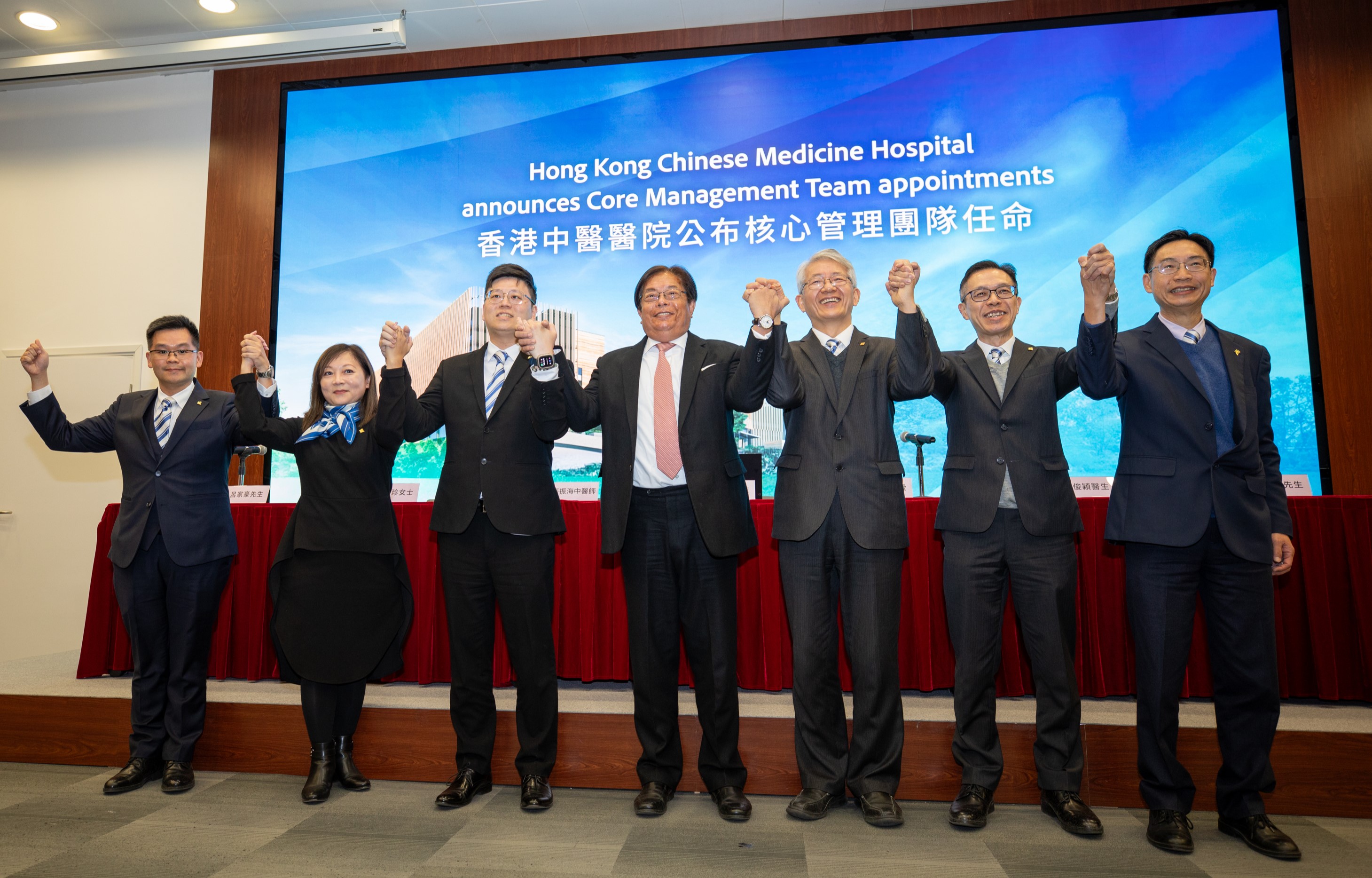 Mr Huen Wong, Chairman of the Board of Directors of the HKBU Chinese Medicine Hospital Company Limited (centre), and the six Core Management Team members. They are Professor Bian Zhaoxiang, Hospital Chief Executive (3rd right); Mr Cheung Chun-hoi, Deputy Hospital Chief Executive (Chinese Medicine) (3rd left); Dr Lau Chun-wing, Deputy Hospital Chief Executive (Western Medicine) (2nd right); Ms Ellie Chon Mei-chun, General Manager (Nursing) (2nd left); Mr Leo Law Kwong-kuen, General Manager (Administrative Services & HR) (1st right); and Mr Leo Lui Ka-ho, General Manager (Finance) (1st left).